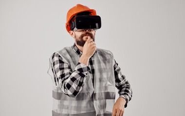 Civil engineer wearing 3D virtual reality glasses and an orange hard hat on his head