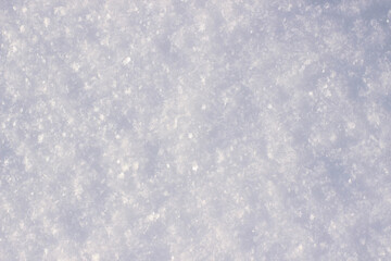 White fluffy snow and snowflakes glistening in the sun