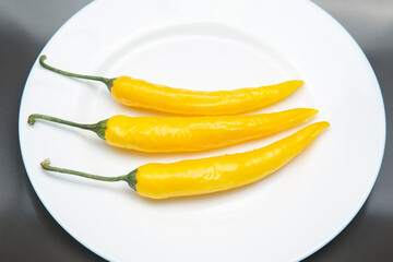 yellow hot chili on a plate. Pepper. Vegetable vitamin food.