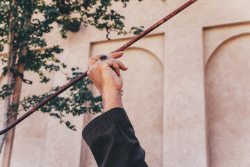 Arabic man spinning stick yowla - obrazy, fototapety, plakaty
