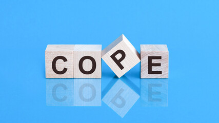 Cope from wooden letters on black background. Social concept.