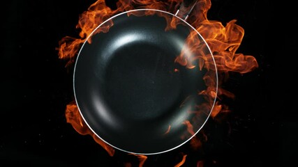 Super slow motion of empty wok pan and fire blast on black background. Filmed on very high speed cinema camera, 1000 fps.