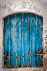 Rusty old blue window, clearly weathered by the passing of time, but still beautiful in its own way.