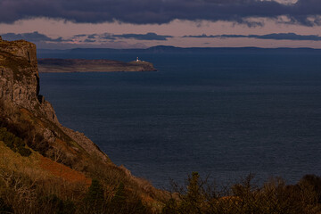 Fototapeta na wymiar Fairhead, Rathlin Island East Lighthouse and The Isle of Islay in Scotland from Murlough Bay, Causeway coastal route, Causeway coast and Glens, County Antrim, Northern Ireland