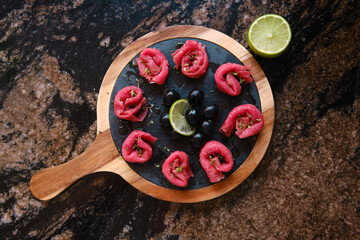 meat carpaccio with olives and lime