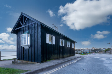 Fototapeta premium black wooden hut on Falmouth sea front cornwall England uk 