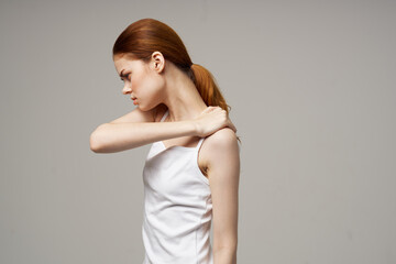 Fototapeta premium woman holding herself by the shoulders on beige background cropped view
