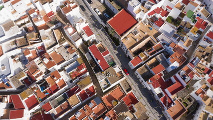 Aerial top view of typical Andalusian town in south Spain in christmas. Conil de la Frontera seen from a drone view with reed rooftops and white buildings