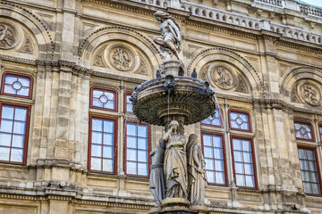 Details of marble water fountain (1869) near Vienna Opera house (Staatsoper). Karajan-Platz, Vienna, Austria.