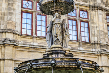 Fototapeta na wymiar Details of marble water fountain (1869) near Vienna Opera house (Staatsoper). Karajan-Platz, Vienna, Austria.