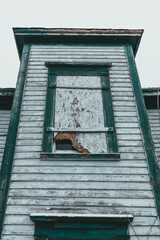 Old abandoned White salt box House in newfoundland