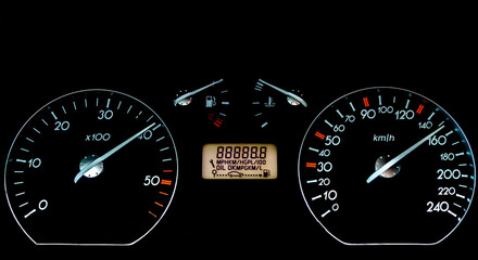 Car dashboard on a black surface. Car instrumental panel with warning signs and warnings. Car speedometer
