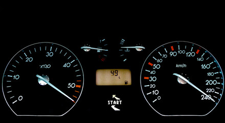 Fototapeta premium Car dashboard on a black surface. Car instrumental panel with warning signs and warnings. Car speedometer