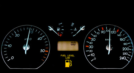 Fototapeta premium Car dashboard on a black surface. Car instrumental panel with warning signs and warnings. Car speedometer