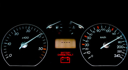 Fototapeta premium Car dashboard on a black surface. Car instrumental panel with warning signs and warnings. Car speedometer