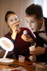 two mimes a guy and a girl are preparing for a performance