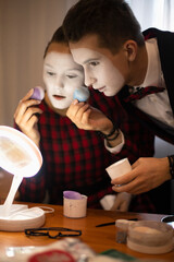mime artists in front of the mirror do makeup