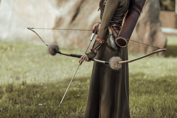 Bow and arrow close-up, female archer.