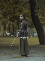 Portrait of lovely woman with ancient quiver with arrows and bow