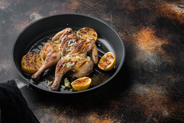 Homemade chicken rotisserie with thyme, lemon, on old rustic background with copy space for text