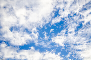 Blue sky background with abstract white clouds