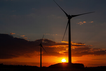 Two windmills in the sunset