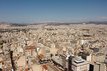 Beautiful historic city of Athens during sunny day and mountains in background,Greece.