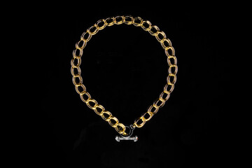 Fototapeta na wymiar Golden jewelry chain with medallion isolated on black background