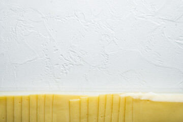 Slices of yellow cheese in sealed pack, on white background with copy space for text - Powered by Adobe
