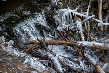 Powerful growths of ice from water splashes on the creek