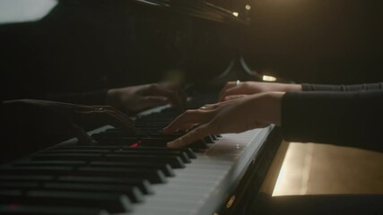 Female pianist plays In Grand Piano On Stage. Black background. Close Up hand. - Powered by Adobe
