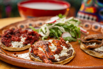 Close up of Mexican spicy meat sopes 