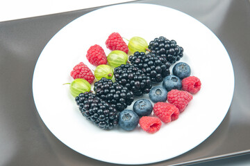 Assorted fresh different berries on a white background. useful vitamin healthy food fruit. healthy vegetable breakfast