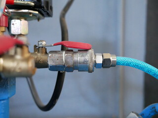 closeup of air compressor system in garage.
