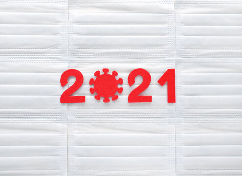 Red Felt Year Numbers 2021 On White Respirators Background. First Zero In The Form Of A Covid Virus. Review Of Effectiveness Vaccination Against Coronavirus. Results Of Last Year.