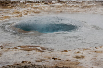 Strokkur Geyser forming blue bubble before erupting, Geysir, Iceland
