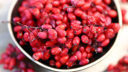 Fresh barberry in a bowl. Red berries of barberry.