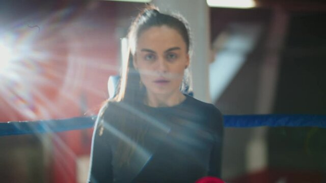 An attractive woman with long hair boxing towards the camera