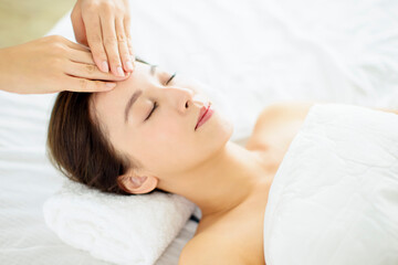 Obraz na płótnie Canvas relaxed Young woman enjoy massage in spa salon