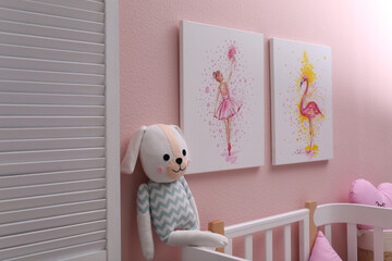 Beautiful pictures of flamingo and ballerina on pink wall in baby room. Interior design