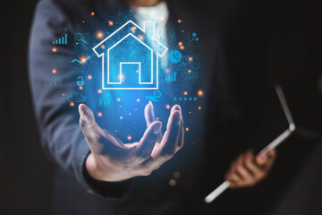 Insurance concept Businessman on hand shows a house icon that transact with corporate sector...