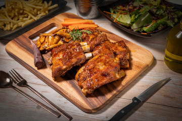 Grilled sliced barbecue pork ribs on wooden plate. Delicious Pork Spare Ribs BBQ seasoned with a spicy basting sauce.