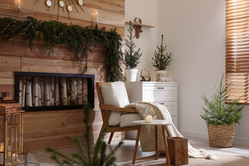 Beautiful room decorated for Christmas with potted firs. Interior design