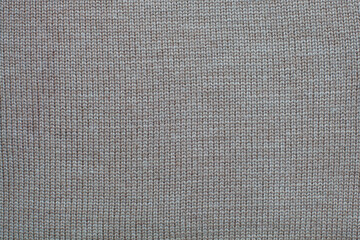 Fototapeta na wymiar Light brown wool knitted canvas, hand knit, plain knitting, horizontal photo