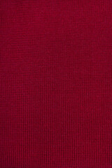 Fototapeta premium Red wool knitted canvas, hand knit, plain knitting, clouseup, vertical photo