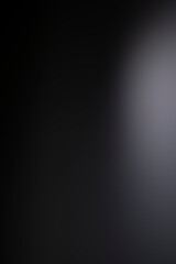 Dark black and gray background has a little abstract light.
