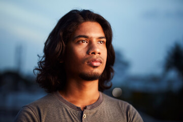 Fototapeta premium Young man portrait with long hair in evening light