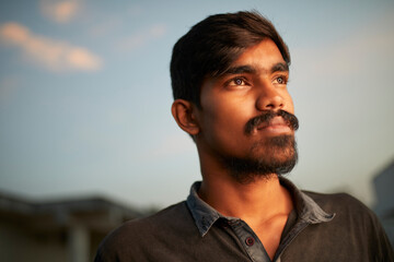 Portrait of Indian young man in evening light in outdoor.