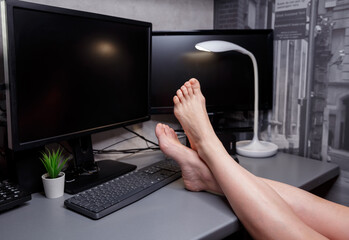 Cropped shot of unrecognizable man sitting on the chair at home, using laptop computer, browsing the web, drinking hot beverage. Working from home during self isolation period. Business, remote work