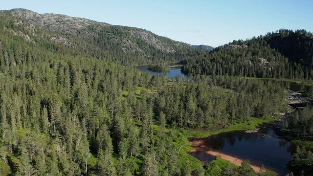 Aerial view overlooking the Mane river, near the RjukanFossen waterfall, sunny, summer day, in Tinn, Agder, South Norway - dolly, drone shot